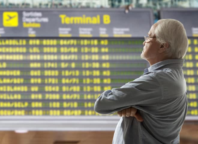 Un senior dans un terminal d'aéroport.